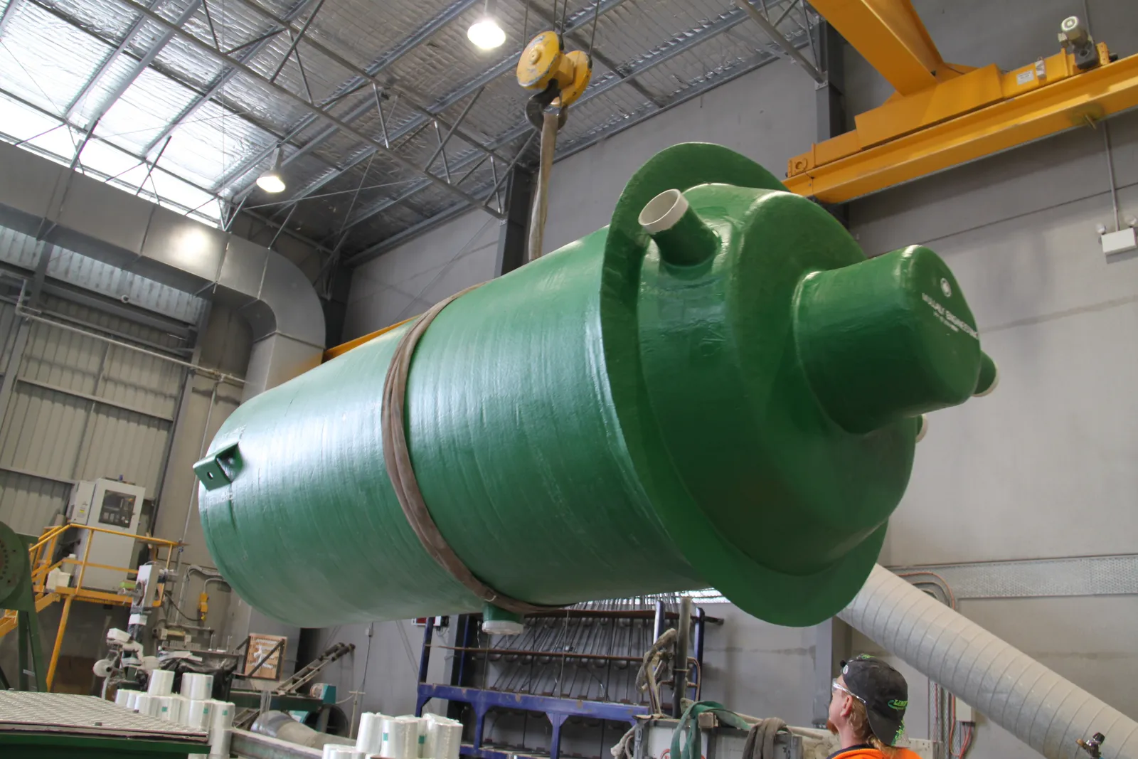Green Mullaly fibreglass unit lifted on the overhead crane in the factory