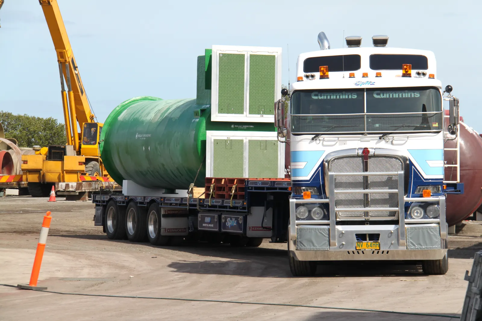 Mullaly FRP pump station with twin access kiosks on a Kenworth semi-trailer beside a crane, ready to leave for Cairns